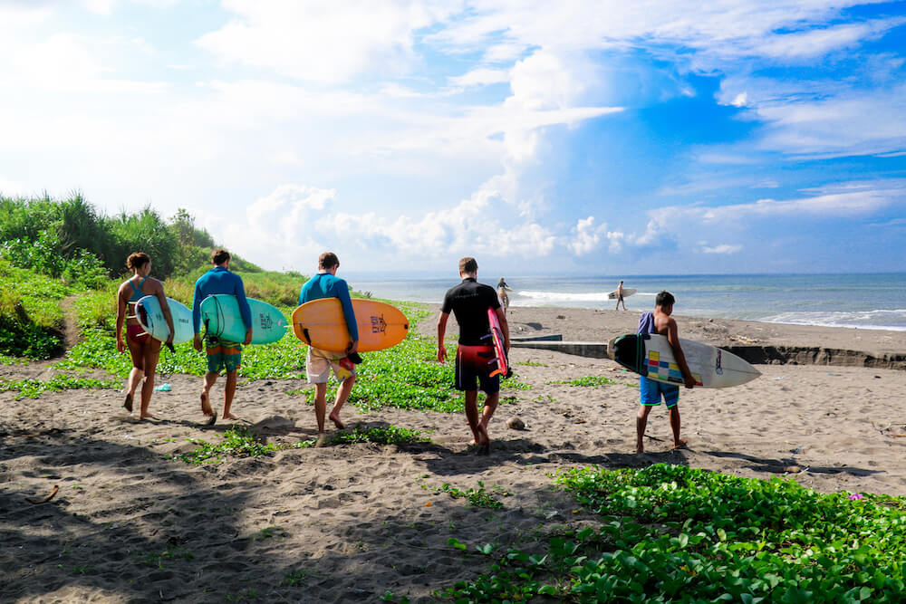 SurfWG guests heading out to surf with their boards
